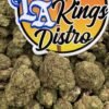 Close-up of Blue Zushi Lows cannabis flower buds beneath the LA Kings Distro logo
