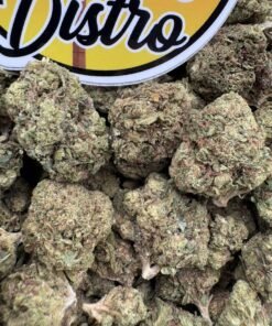 Green Cookie Monster Lows cannabis flower buds with orange pistils beside the LA Kings Distro logo