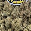 Close-up of chunky green Toxic Lemon Lows cannabis buds beneath the LA Kings Distro sign