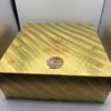 Open gold soccer-ball case holding an Authentic Ace 2G Disposable World Cup Edition device and collectible ring