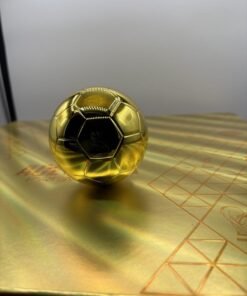 Open gold soccer-ball case holding an Authentic Ace 2G Disposable World Cup Edition device and collectible ring