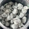 Open jar of Piff Snowball Minis coated buds beside winter-themed 16-flavor packaging