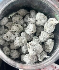 Open jar of Piff Snowball Minis coated buds beside winter-themed 16-flavor packaging