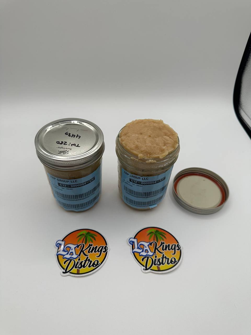Cat 3 licensed cannabis badder concentrate in glass jars showing creamy golden-tan texture Cat 3 licensed cannabis badder concentrate in glass jars showing creamy golden-tan texture