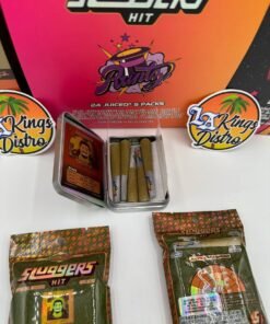 Open Sluggers Hit collectible tin showing five infused JUICED pre-rolls with Sluggers packaging in background