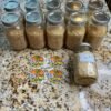 Cat 3 Clean Lab Tested Sugar cannabis concentrate in bulk glass jars with light golden crystalline texture