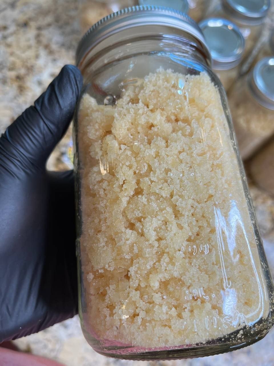 Cat 3 Clean Lab Tested Sugar cannabis concentrate in bulk glass jars with light golden crystalline texture Cat 3 Clean Lab Tested Sugar cannabis concentrate in bulk glass jars with light golden crystalline texture