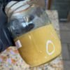 Glass jars labeled 224 Badder containing golden Cat 3 cannabis concentrate