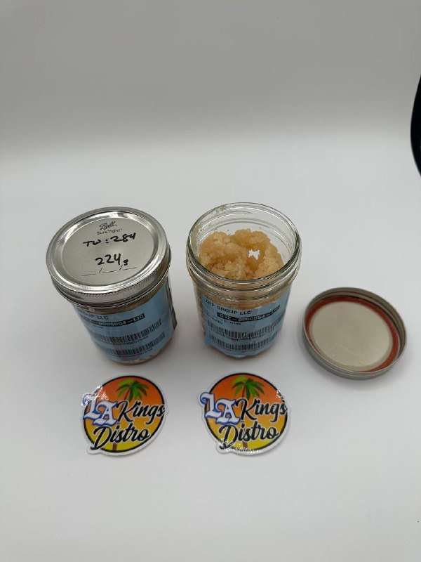 Cat 3 licensed lab-tested cannabis sugar concentrate displayed in glass jars with golden crystal texture Cat 3 licensed lab-tested cannabis sugar concentrate displayed in glass jars with golden crystal texture