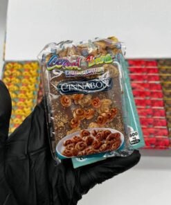 Cinnabon-themed Cereal Bars 600MG cannabis-infused chocolate bar held in a gloved hand