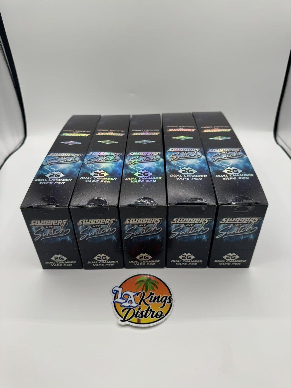 Sluggers Hit Switch 2G Dual Chamber Vape Pen boxes showing multiple color-coded strain varieties Sluggers Hit Switch 2G Dual Chamber Vape Pen boxes showing multiple color-coded strain varieties
