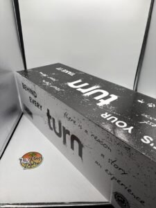 Turn One 2G disposable cannabis vape in black with Botanica Blends Magic Melon and White Gummy Bear packaging