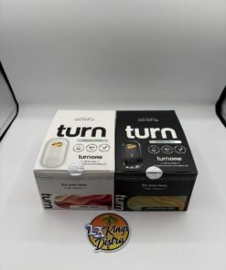 Turn One 2G disposable vapes displayed with Magic Melon and White Gummy Bear Botanica Blends packages