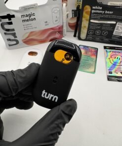 Turn One 2G disposable vapes displayed with Magic Melon and White Gummy Bear Botanica Blends packages